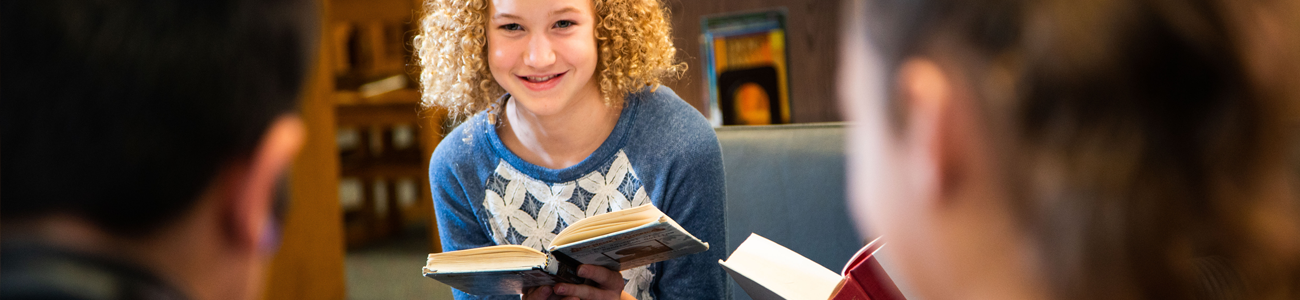 girl on couch with a book 